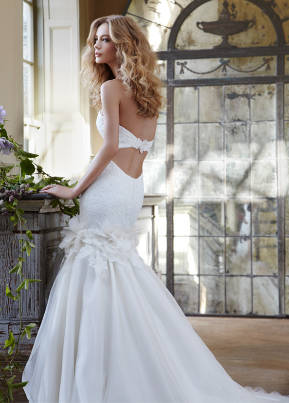 A corded embroidered ivory lace fittoflare bridal gown with flower and 